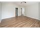 This bedroom is spacious with hardwood floors and ample lighting, ready for personalized decoration at 8432 Spirea Ct, Charlotte, NC 28215