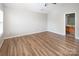 Bedroom features wood-look floors and a doorway into the bathroom at 8432 Spirea Ct, Charlotte, NC 28215