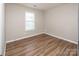 Bedroom featuring wood floors, one window, and a neutral paint scheme at 8432 Spirea Ct, Charlotte, NC 28215