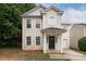 Two-story home featuring a light yellow exterior, a black front door, and a concrete driveway at 8432 Spirea Ct, Charlotte, NC 28215