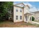Charming two-story home with a light yellow exterior and a welcoming front porch at 8432 Spirea Ct, Charlotte, NC 28215