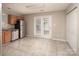 Open kitchen features tile flooring, stainless steel appliances, and access to the exterior at 8432 Spirea Ct, Charlotte, NC 28215