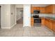 Bright kitchen features stainless steel appliances, granite countertops, and tile flooring at 8432 Spirea Ct, Charlotte, NC 28215