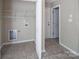 Laundry room with tile flooring, white walls, and shelving and connections for washer and dryer at 8432 Spirea Ct, Charlotte, NC 28215