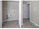 Laundry room with built in shelving, tile flooring, and utility connections at 8432 Spirea Ct, Charlotte, NC 28215