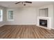 Sunlit living room boasts hardwood floors, a fireplace, and neutral paint colors at 8432 Spirea Ct, Charlotte, NC 28215