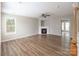 Bright living room with hardwood floors, a fireplace and a ceiling fan at 8432 Spirea Ct, Charlotte, NC 28215