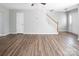 Open living room featuring wood floors, stairs, and a front door at 8432 Spirea Ct, Charlotte, NC 28215