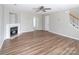 This is a large living room with a fireplace and hardwood flooring at 8432 Spirea Ct, Charlotte, NC 28215
