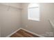 The walk-in closet boasts shelving, a window, and hardwood floors, providing an organized space at 8432 Spirea Ct, Charlotte, NC 28215