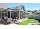 Inviting backyard featuring a patio with seating, a screened-in porch, and a well-manicured lawn at 9062 Treetop Nw Way, Concord, NC 28027