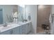 Bright bathroom features double vanity, modern fixtures, decorative accents, and a tiled walk-in shower at 9062 Treetop Nw Way, Concord, NC 28027