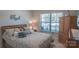 Comfortable bedroom featuring a queen-sized bed with decorative pillows, a window with blinds, and a wooden dresser at 9062 Treetop Nw Way, Concord, NC 28027