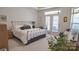 Comfortable bedroom with french doors to outdoor space, and large window with natural light at 9062 Treetop Nw Way, Concord, NC 28027