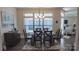 Dining area features a sleek glass table and stylish chandelier for elegant dining at 9062 Treetop Nw Way, Concord, NC 28027