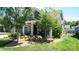 Beautiful single-Gathering home showcasing a manicured lawn, stone accents, and a welcoming front porch at 9062 Treetop Nw Way, Concord, NC 28027