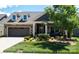 Charming single-Gathering home featuring a well-maintained front yard, stone accents, and an attached two-car garage at 9062 Treetop Nw Way, Concord, NC 28027