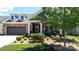 Charming single-Gathering home featuring a well-maintained front yard, stone accents, and an attached two-car garage at 9062 Treetop Nw Way, Concord, NC 28027