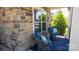 Charming porch with stone facade and stylish seating arrangement at 9062 Treetop Nw Way, Concord, NC 28027