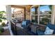 Inviting front porch featuring comfortable seating, stylish decor, and attractive brick accents at 9062 Treetop Nw Way, Concord, NC 28027