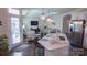 Open-concept kitchen with a marble island, modern pendant lighting, and seating for casual dining at 9062 Treetop Nw Way, Concord, NC 28027