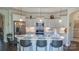 Spacious kitchen with white cabinets, a marble island, stainless steel appliances, and modern pendant lighting at 9062 Treetop Nw Way, Concord, NC 28027