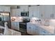 Well-lit kitchen with stainless steel appliances, white cabinets, subway tile backsplash, and marble countertops at 9062 Treetop Nw Way, Concord, NC 28027