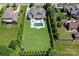 Expansive backyard featuring a sparkling pool, lush lawn, and meticulously maintained greenery at 9807 Aristides Dr, Waxhaw, NC 28173