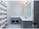 Neutral bathroom featuring a sleek gray vanity, quartz countertop, and elegant lighting at 9807 Aristides Dr, Waxhaw, NC 28173