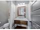 Charming powder room features a wooden vanity with marble countertop and decorative mirror at 9807 Aristides Dr, Waxhaw, NC 28173