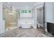 Luxurious bathroom with soaking tub, glass shower, and herringbone tile floors at 9807 Aristides Dr, Waxhaw, NC 28173