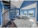 Bright bedroom with spiral staircase, cozy seating, and eye-catching blue walls at 9807 Aristides Dr, Waxhaw, NC 28173