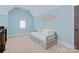 Light blue bedroom featuring a daybed, an arched window, and a surfboard decoration at 9807 Aristides Dr, Waxhaw, NC 28173