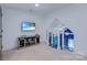 A cozy bonus room with a TV, media center, and staircase to another level at 9807 Aristides Dr, Waxhaw, NC 28173