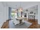 Bright dining room with hardwood floors, shiplap walls, stylish pendant lights, and neutral decor at 9807 Aristides Dr, Waxhaw, NC 28173