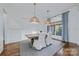Bright dining room with hardwood floors, shiplap walls, stylish pendant lights, and neutral decor at 9807 Aristides Dr, Waxhaw, NC 28173