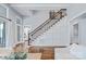 Grand foyer featuring hardwood floors, staircase with iron railings, and an open floor plan at 9807 Aristides Dr, Waxhaw, NC 28173