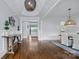 Elegant foyer showcasing hardwood floors, decorative chandelier, and wainscoting details at 9807 Aristides Dr, Waxhaw, NC 28173