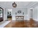 Elegant foyer showcasing hardwood floors, decorative chandelier, wainscoting, and sophisticated decor at 9807 Aristides Dr, Waxhaw, NC 28173