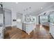 Bright open kitchen featuring a large island, stainless steel appliances, and hardwood floors at 9807 Aristides Dr, Waxhaw, NC 28173