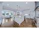 Spacious kitchen with white cabinetry, large island, granite countertops, and stainless steel appliances at 9807 Aristides Dr, Waxhaw, NC 28173