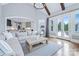 Open-concept living room with hardwood floors, view to kitchen, and access to outdoor space at 9807 Aristides Dr, Waxhaw, NC 28173
