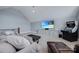 Bright living room with sloped ceilings, large windows, neutral tones, and a vintage arcade game at 9807 Aristides Dr, Waxhaw, NC 28173