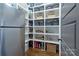 Walk-in pantry with custom shelving, providing ample storage space next to a stainless steel refrigerator at 9807 Aristides Dr, Waxhaw, NC 28173