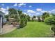 Expansive backyard featuring a stone patio, mature trees, and a lush, green lawn at 998 Emory Ln, Fort Mill, SC 29708