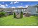 Lovely backyard featuring a stone patio, hot tub, fire pit, and a well-manicured lawn at 998 Emory Ln, Fort Mill, SC 29708