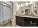 Bathroom featuring a double vanity with granite countertop and shower with floral curtain at 998 Emory Ln, Fort Mill, SC 29708