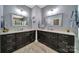 Bathroom featuring double vanities with granite countertops and elegant mirrors at 998 Emory Ln, Fort Mill, SC 29708