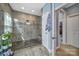 Bathroom featuring walk-in shower with mosaic tile accents and river rock floor at 998 Emory Ln, Fort Mill, SC 29708