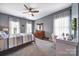 Bedroom features a comfortable bed, natural light, carpeted floors, ceiling fan and neutral colors at 998 Emory Ln, Fort Mill, SC 29708